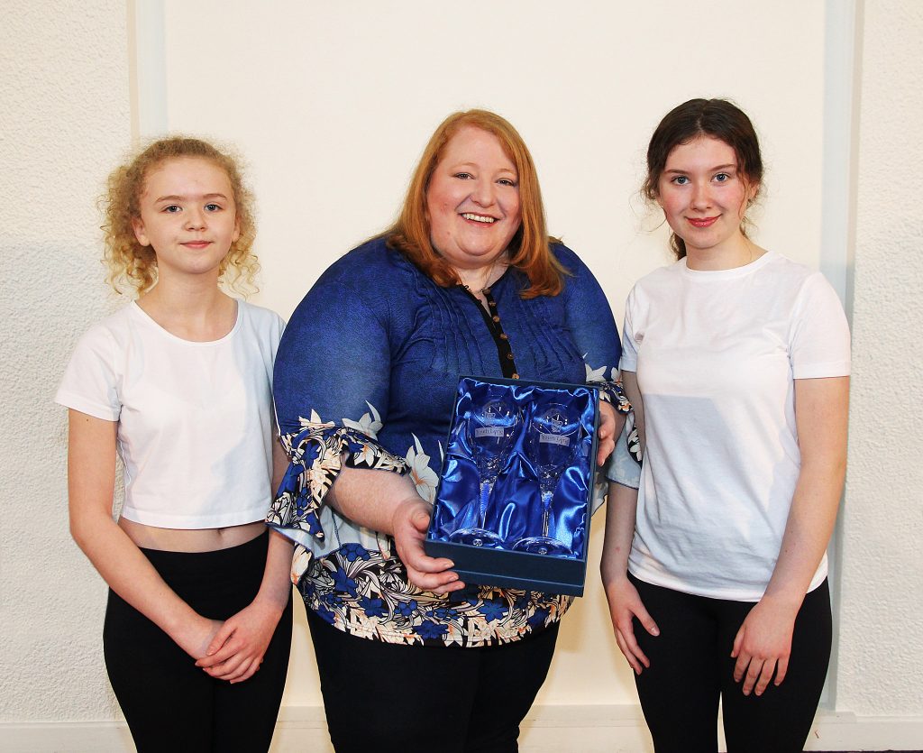 Naomi Long MEP receives Youth Lyric Belfast Crystal glasses from our students.